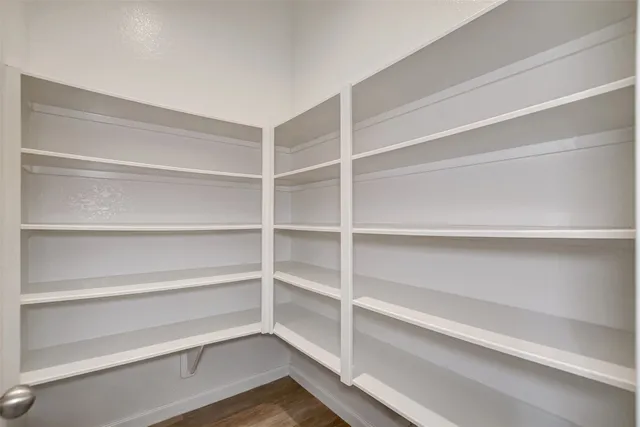 a kitchen with a sink cabinets and wooden floor