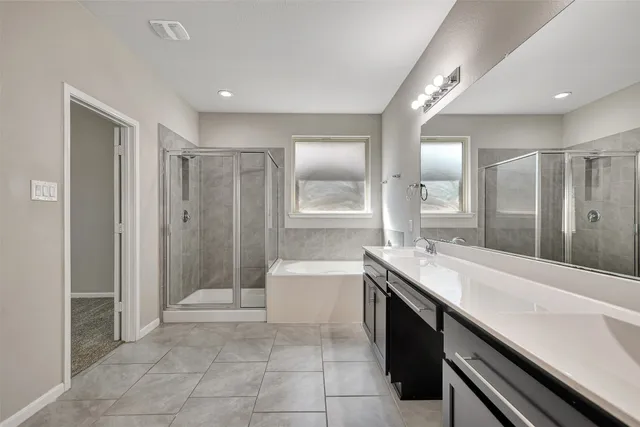 a spacious bathroom with a shower sink vanity and mirror