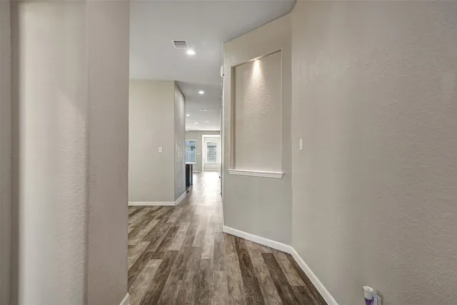 a view of hallway with wooden floor