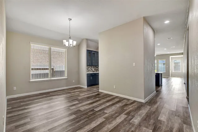 a view of a room with window and wooden floor