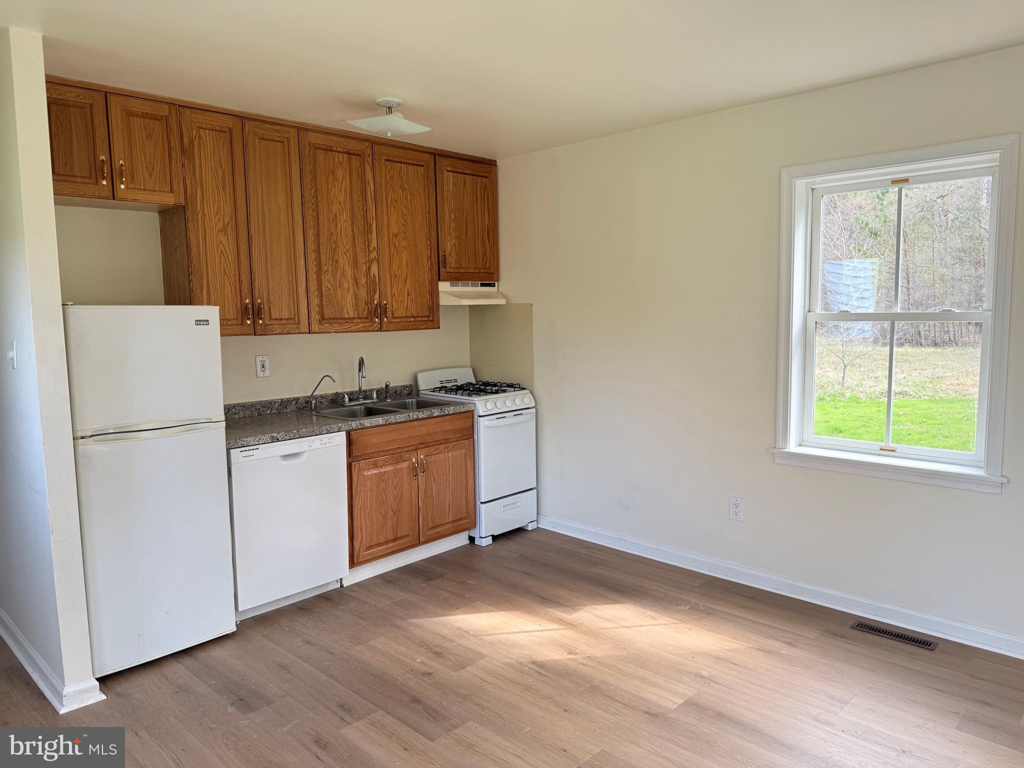 6937 Bellevue Road Royal Oak, MD 21662 - Photo 5 of 9 a kitchen with a refrigerator and a stove top oven
