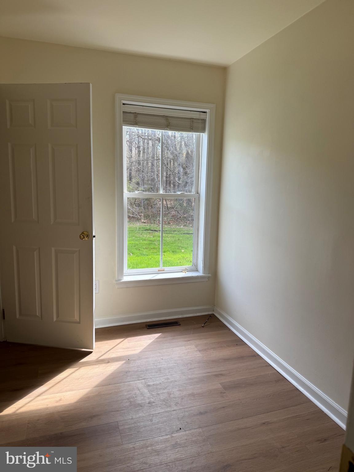 6937 Bellevue Road Royal Oak, MD 21662 - Photo 6 of 9 a view of an empty room with wooden floor and a window
