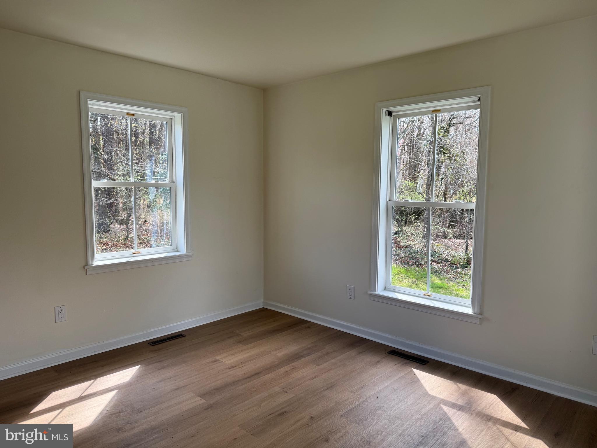 6937 Bellevue Road Royal Oak, MD 21662 - Photo 8 of 9 a view of an empty room with wooden floor and a window