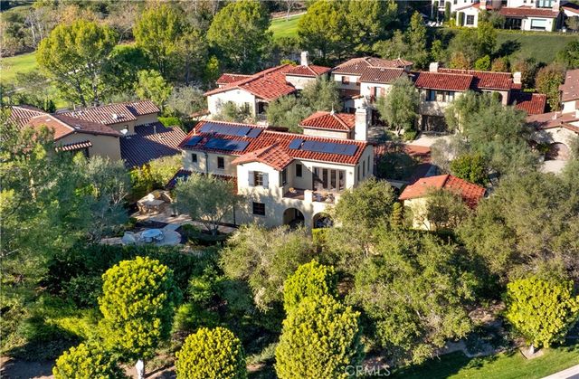 an aerial view of multiple houses with yard