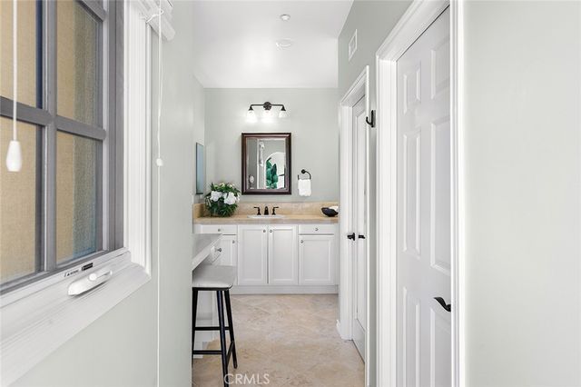 a bathroom with double sink and a mirror