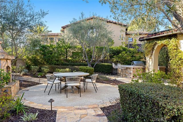 a view of a patio with table and chairs and potted plants
