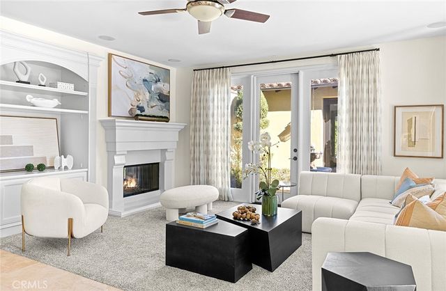 a living room with furniture a flat screen tv and a fireplace