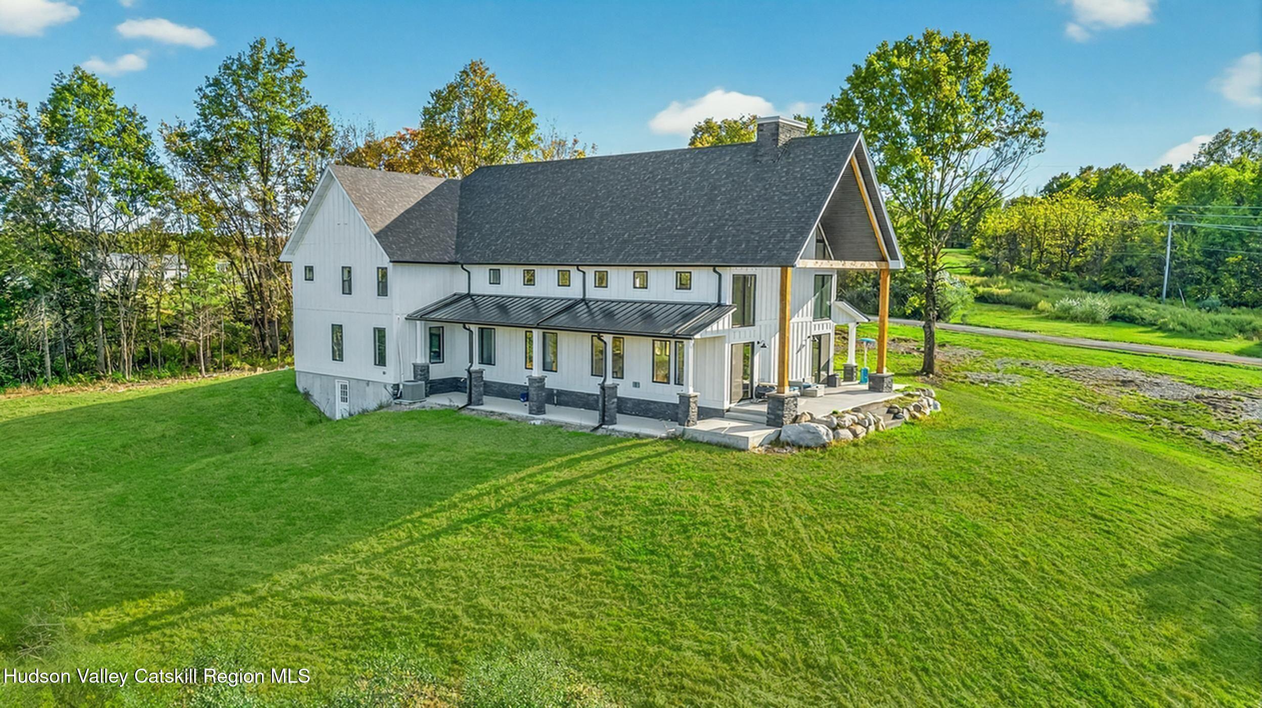 a view of a house with a yard porch and sitting area