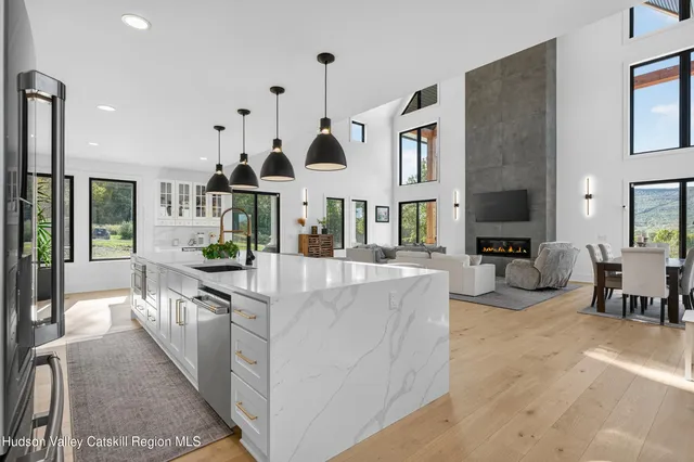 a view of a hallway with a white bath tub and stairs