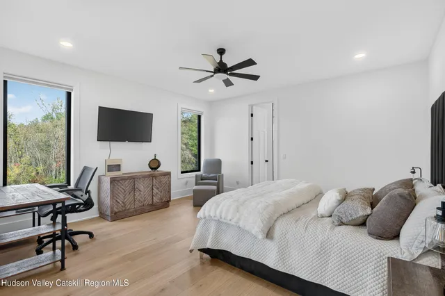 a bedroom with a bed and a flat screen tv