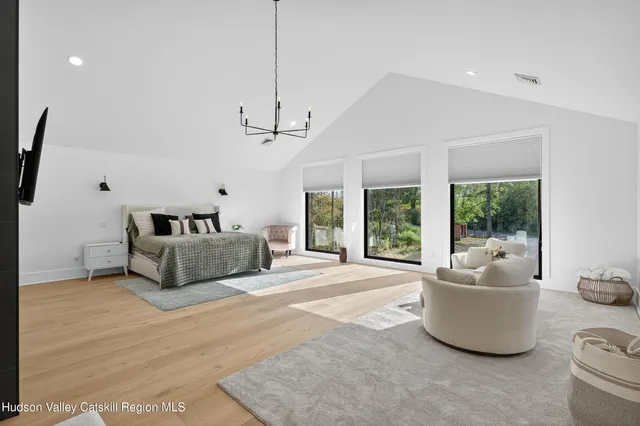 a bedroom with a bed and a television