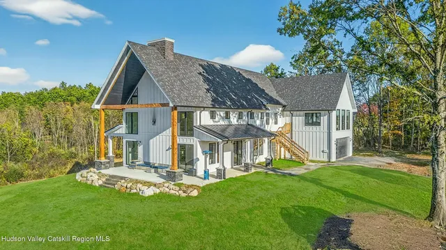 a view of house with garden and tall trees