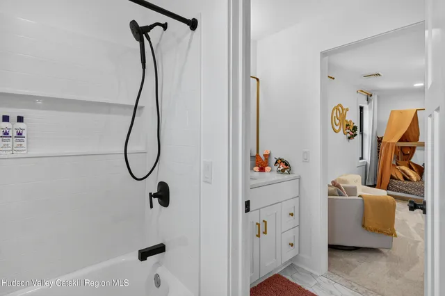 a bedroom with furniture and a window