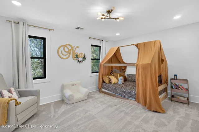 a bedroom with furniture and a flat screen tv