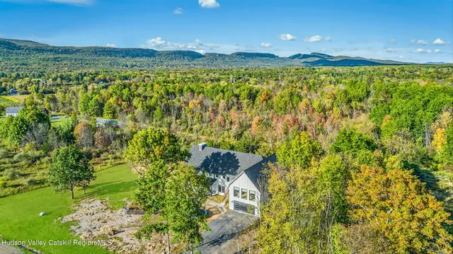 a view of a house with a yard patio and fire pit