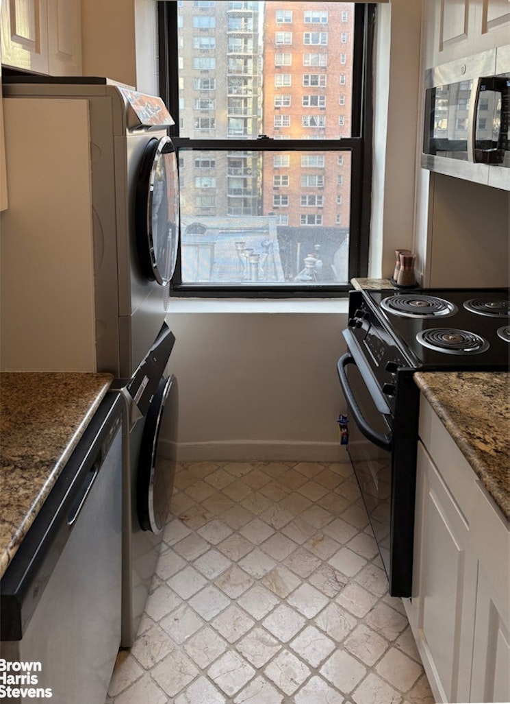 235 East 73rd Street, Unit 8D Manhattan, NY 10021 - Photo 3 of 10 a kitchen with a refrigerator and a stove