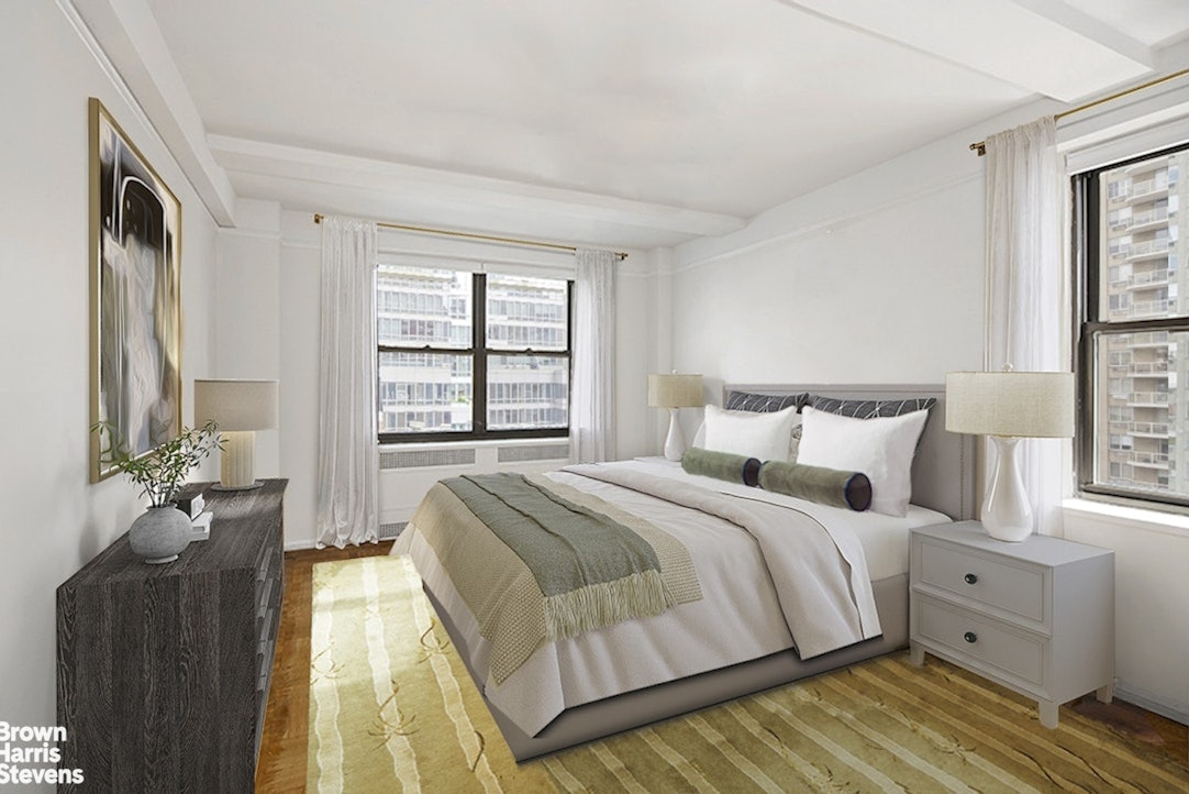 235 East 73rd Street, Unit 8D Manhattan, NY 10021 - Photo 4 of 10 a bedroom with a bed and a large window