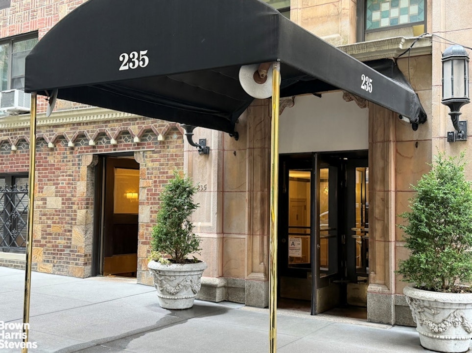 235 East 73rd Street, Unit 8D Manhattan, NY 10021 - Photo 8 of 10 a front view of a house with a porch