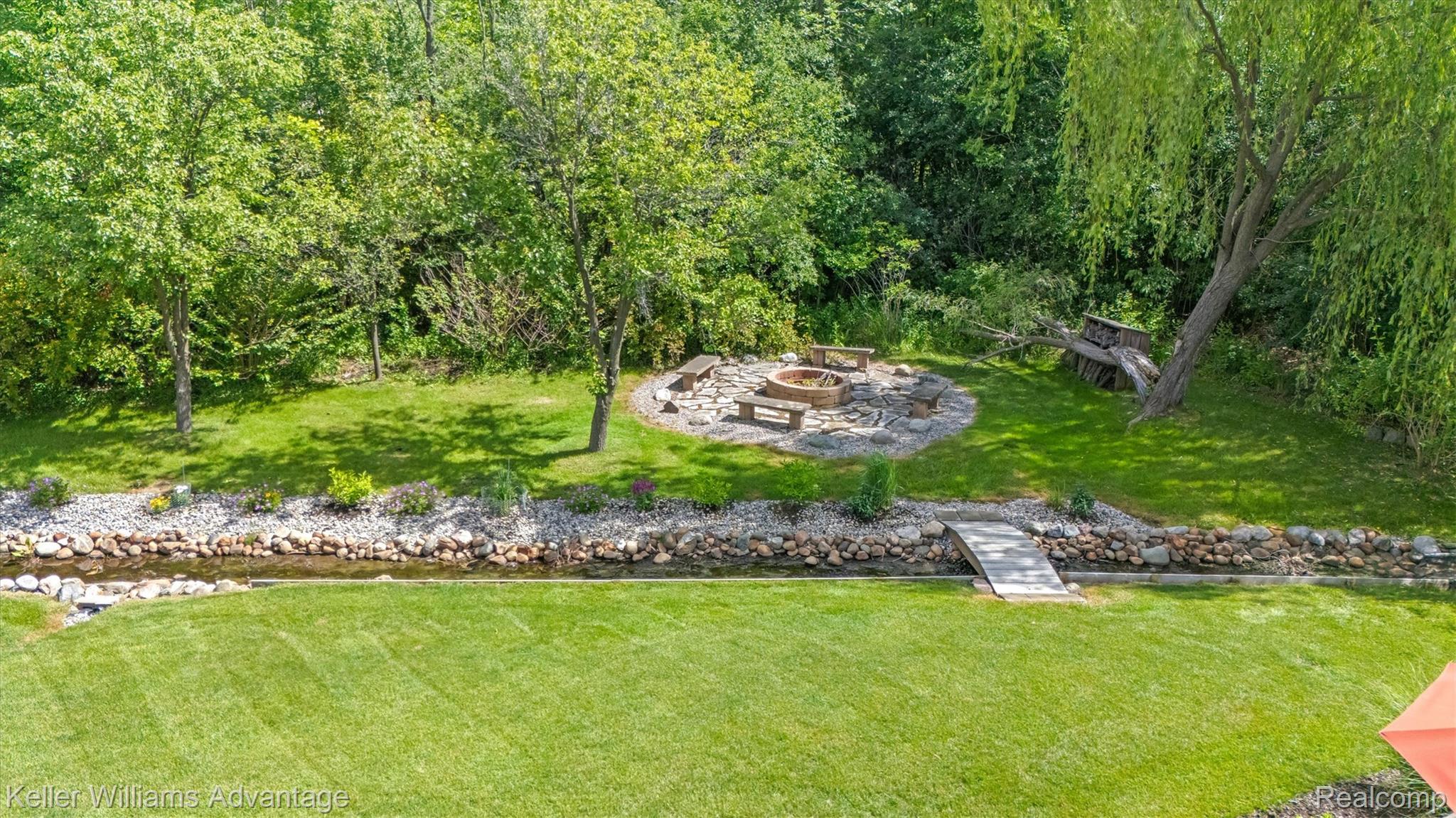 22878 Tree Top Court South Lyon, MI 48178 - Photo 58 of 75 Expansive backyard featuring a manicured lawn