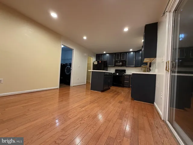 a room with wooden floor and furniture