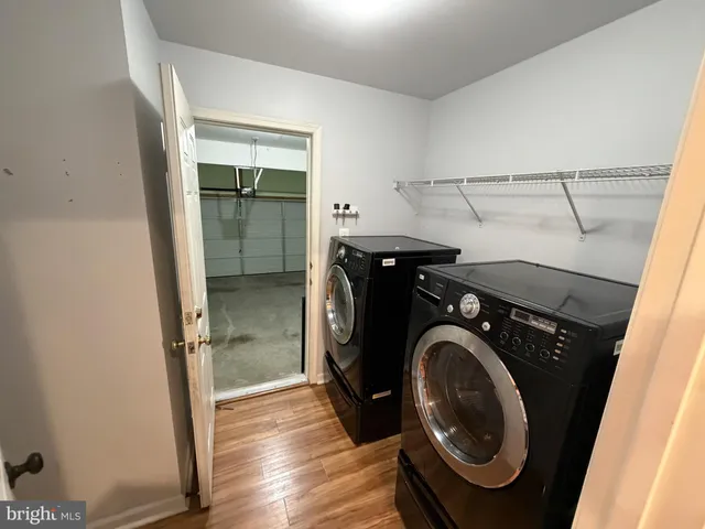 a view of an entryway with wooden floor and a cabinet