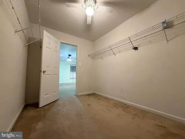 an empty room with an entryway and closet