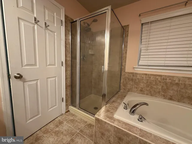 a view of an empty room and a ceiling fan