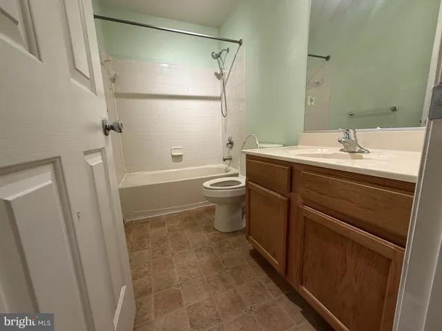 a view of a livingroom with a ceiling fan and window