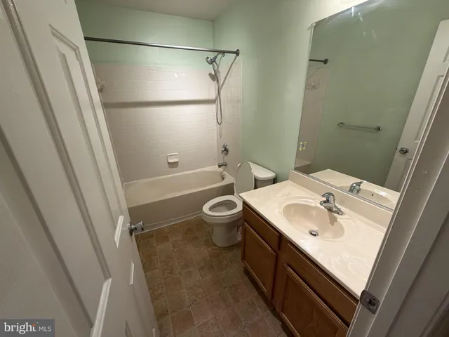 an empty room with a mirror and stairs