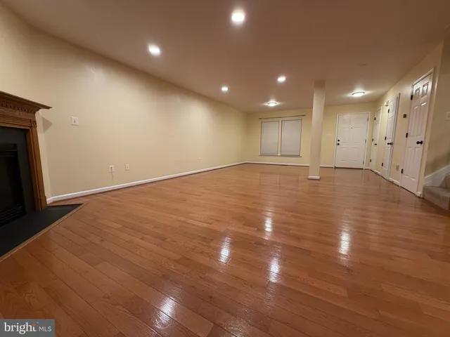 a view of an empty room with stairs and a window