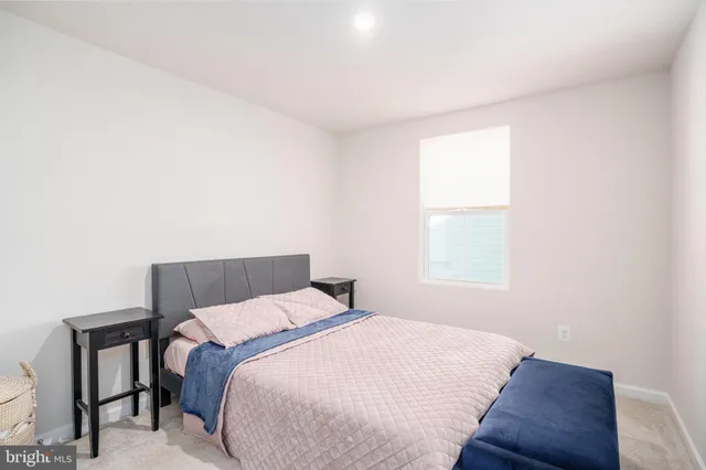 a bathroom with a sink vanity mirror and toilet