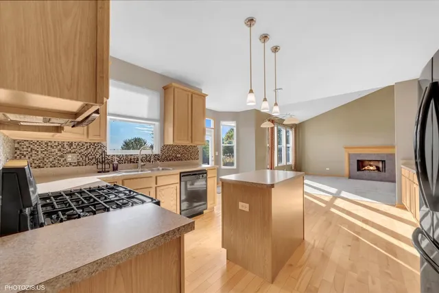 a kitchen with stainless steel appliances granite countertop a sink refrigerator and microwave