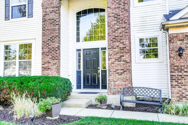 a view of front door of house with outdoor seating