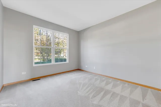 a view of a hallway with wooden floor and a fireplace