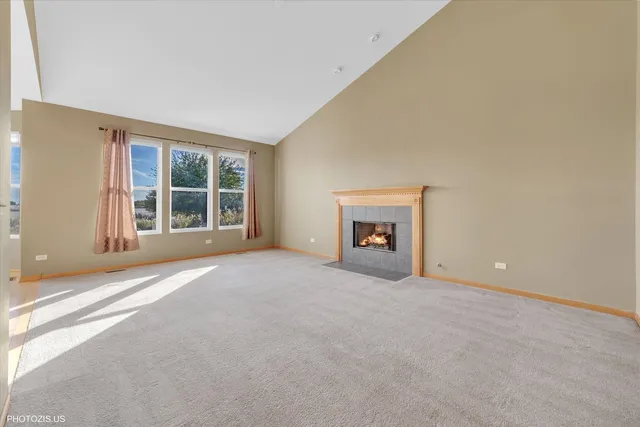 a kitchen with stainless steel appliances granite countertop a refrigerator a stove a sink dishwasher and white cabinets with wooden floor