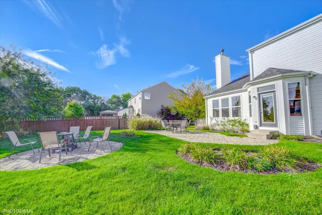 a view of a chair and table in backyard