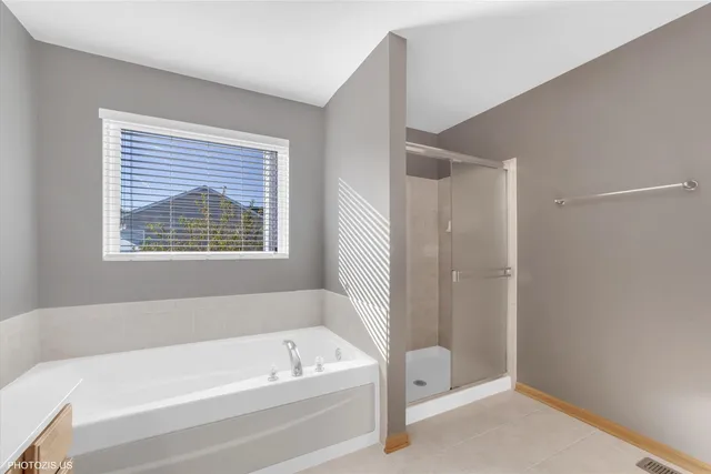 a spacious bathroom with a granite countertop sink mirror and a shower