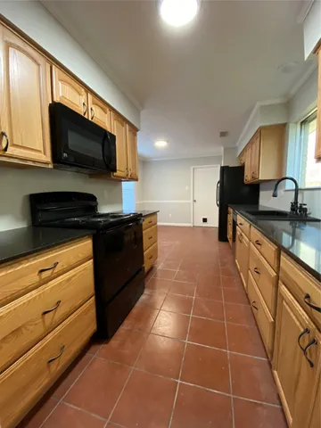 a kitchen with stainless steel appliances a sink a stove a microwave and cabinets