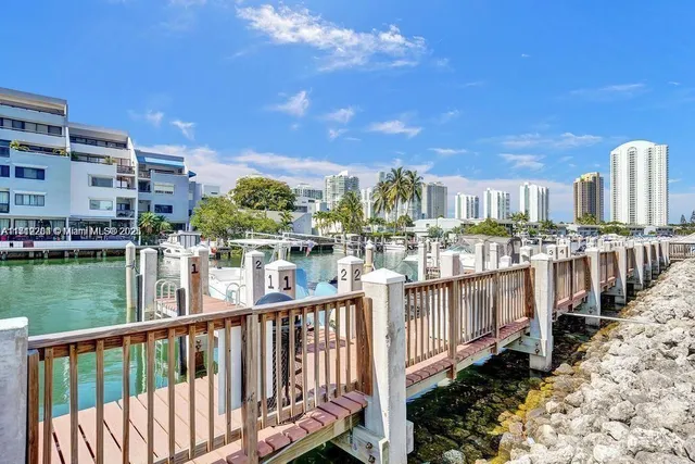 a city view with boat and palm trees
