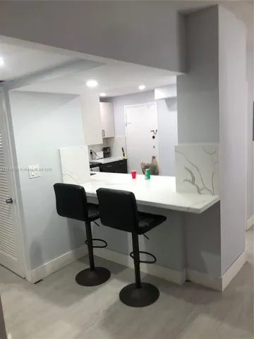 a kitchen with a sink cabinets and appliances