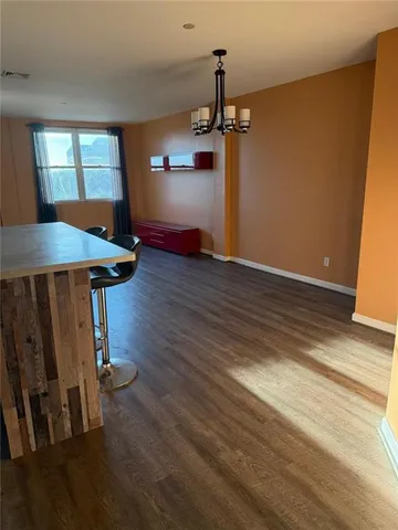 a view of a room with wooden floor