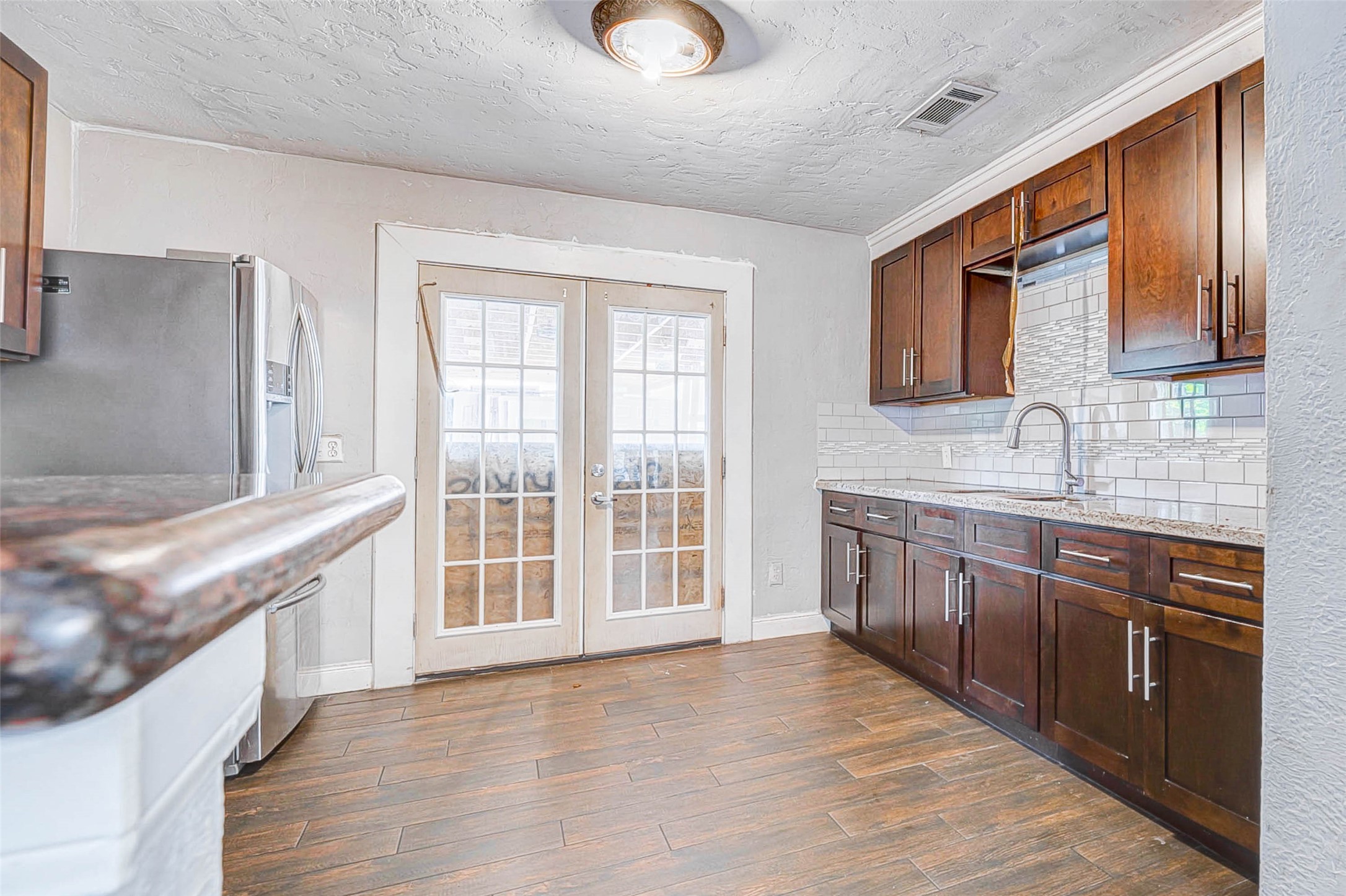 3623 Inez Street Fresno, TX 77545 - Photo 12 of 33 a large kitchen with stainless steel appliances granite countertop a sink and wooden cabinets