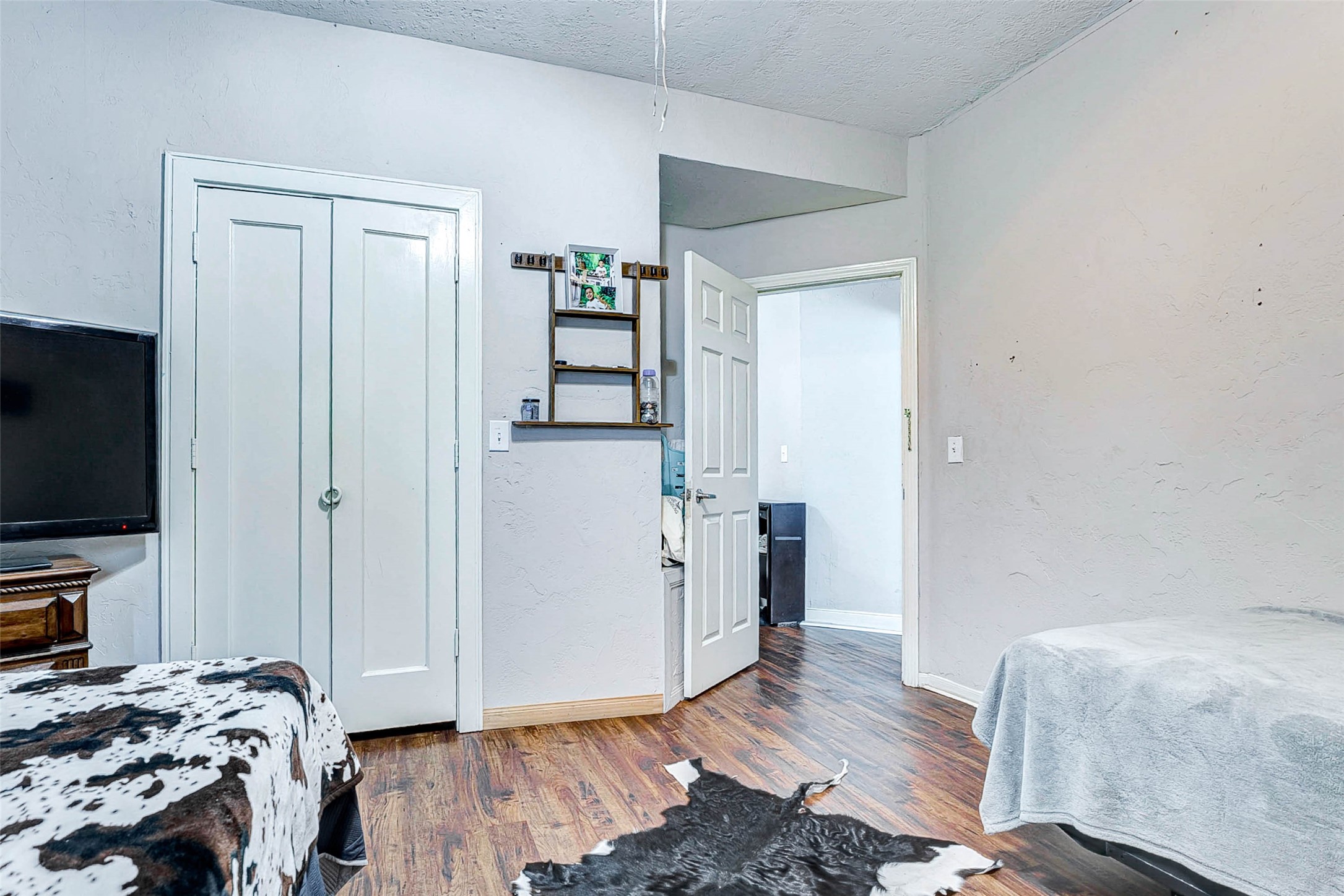 3623 Inez Street Fresno, TX 77545 - Photo 28 of 33 a bedroom with a bed and wooden floor