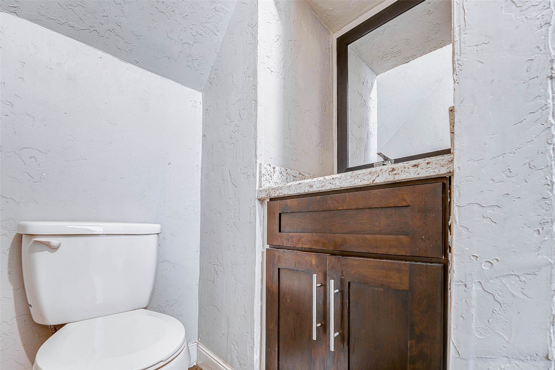 3623 Inez Street Fresno, TX 77545 - Photo 8 of 33 a white toilet sitting next to a bathroom sink