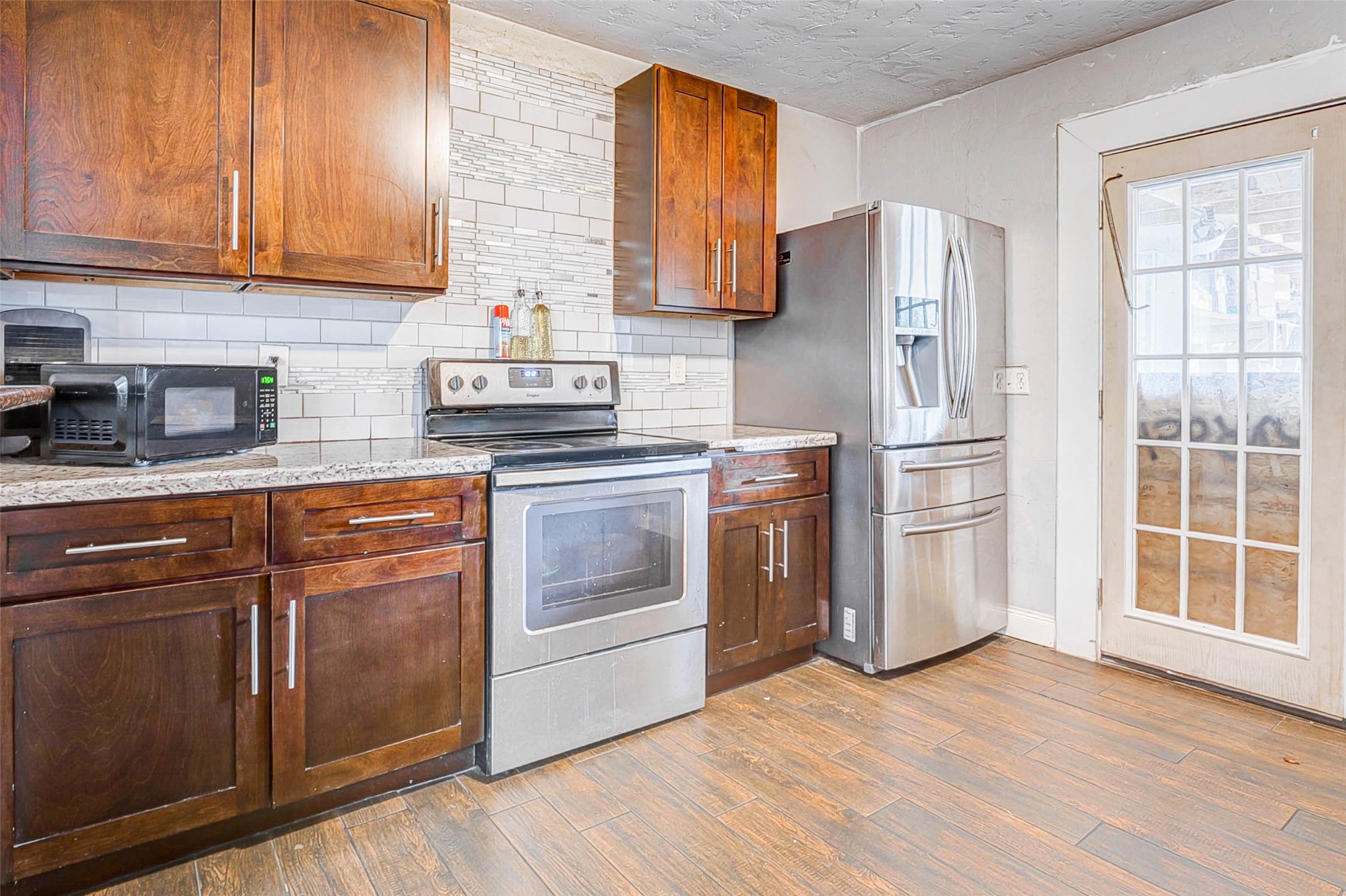 3623 Inez Street Fresno, TX 77545 - Photo 10 of 33 a kitchen with stainless steel appliances granite countertop a refrigerator sink and cabinets
