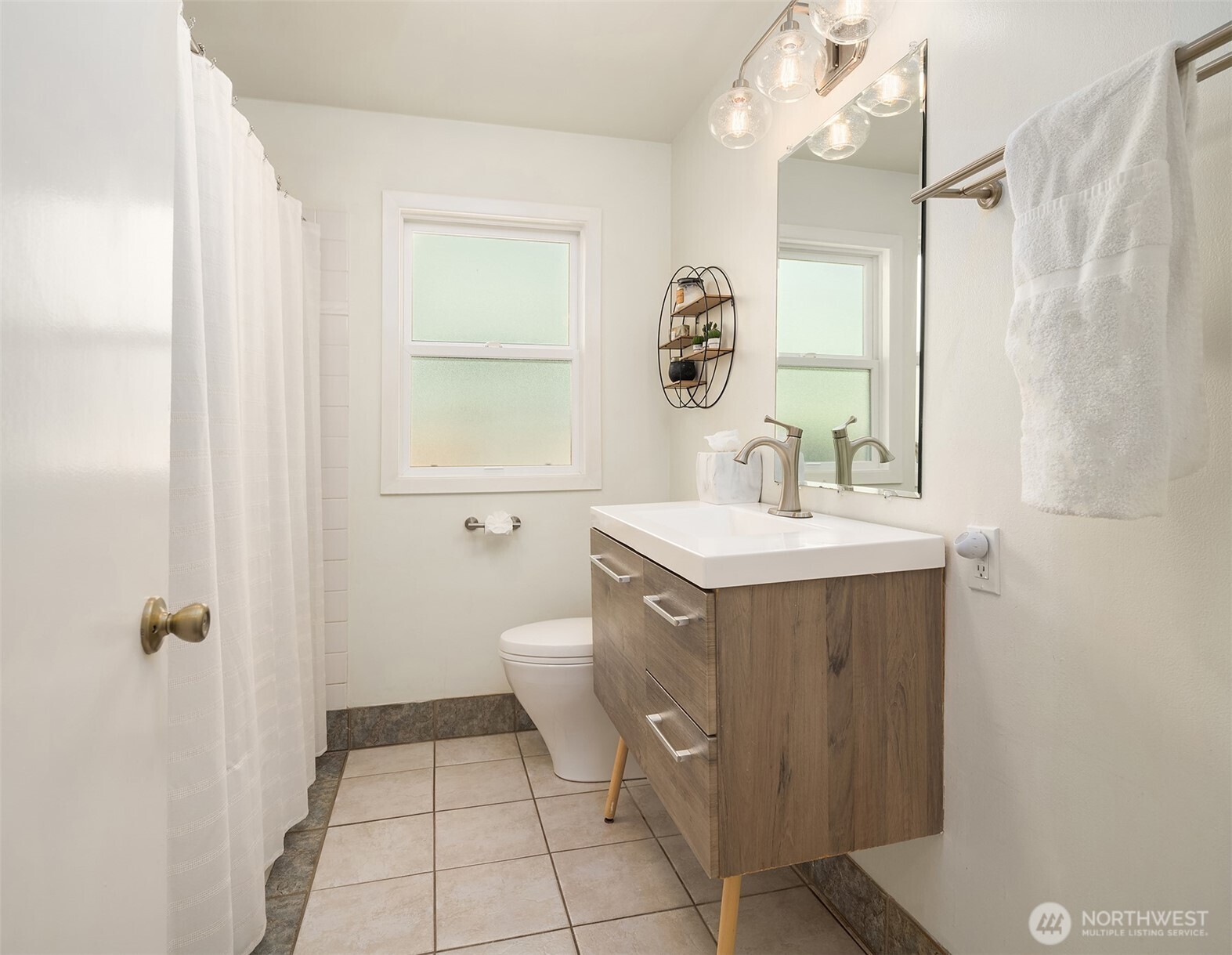 6034 40th Avenue Northeast Seattle, WA 98115 - Photo 17 of 40 a bathroom with a sink a toilet and mirror
