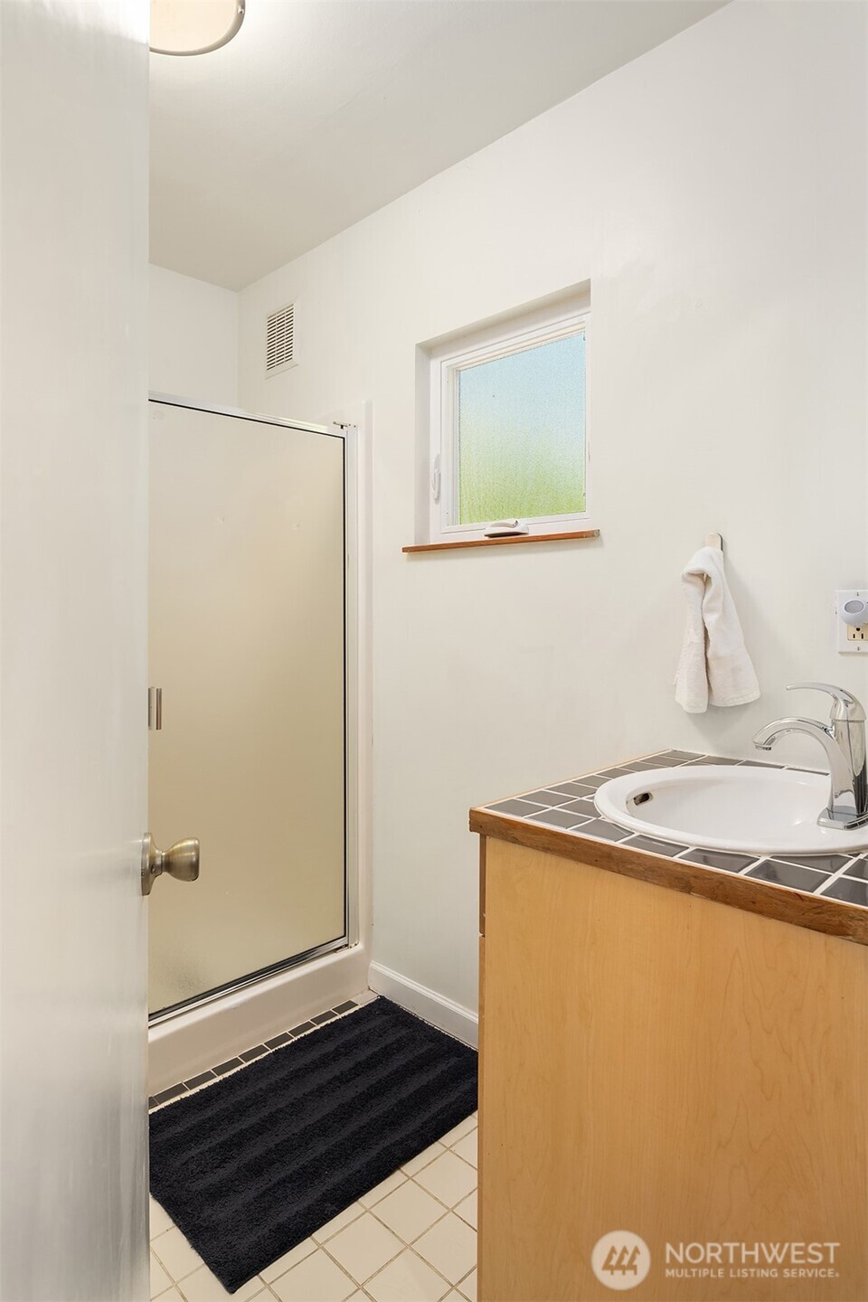 6034 40th Avenue Northeast Seattle, WA 98115 - Photo 18 of 40 a bathroom with a sink and a shower