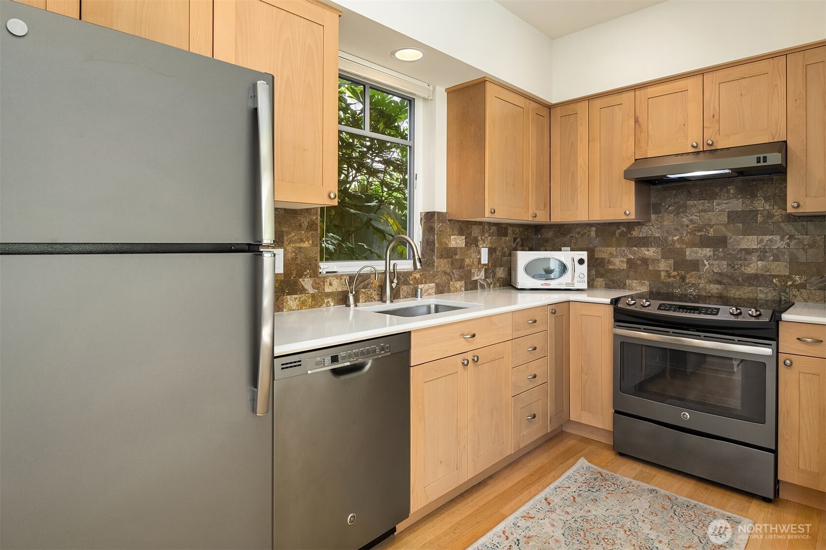 6034 40th Avenue Northeast Seattle, WA 98115 - Photo 34 of 40 a kitchen with a sink a refrigerator and a window