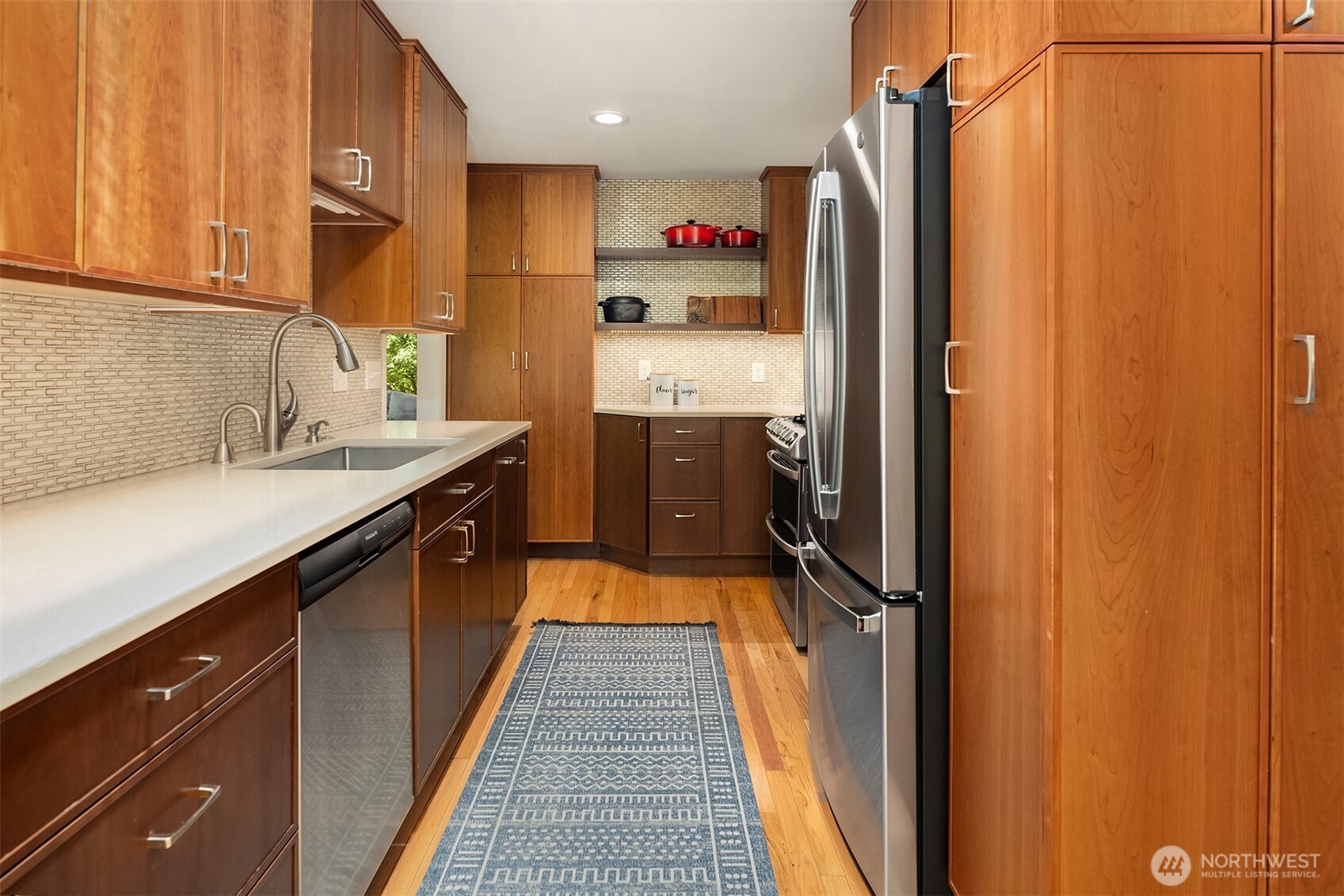 6034 40th Avenue Northeast Seattle, WA 98115 - Photo 10 of 40 a kitchen with stainless steel appliances a refrigerator and a sink
