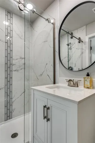 a bathroom with a sink vanity and a mirror